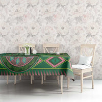 Green tribal geometric tablecloth with diamond and wave motifs on dining table