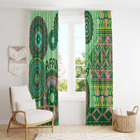 Green window curtains with circular tribal motifs and zigzag geometric bands