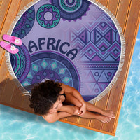 Purple round beach blanket with tribal geometric motifs and white fringed border
