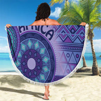 Purple round beach blanket with AFRICA lettering, tribal motifs, white fringe border outdoors