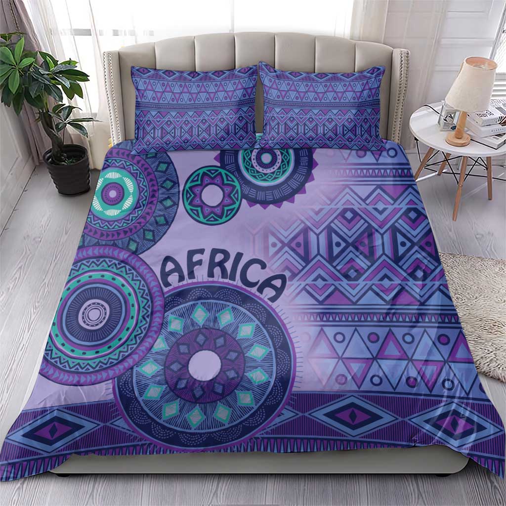 Purple bedding set with large circular tribal artwork and “AFRICA” text on duvet