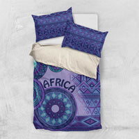 Purple bedding set with large tribal circle motifs and “AFRICA” text on duvet