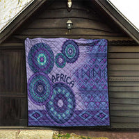Purple tribal quilt hung up with teal circular motifs, geometric borders, and "AFRICA"