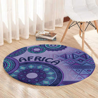 Purple round area rug with teal geometric details and AFRICA lettering across center