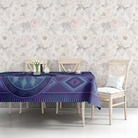 Purple tribal pattern tablecloth on dining table with chairs and vases