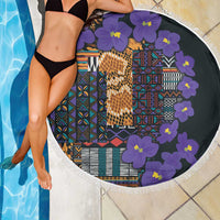 Round beach blanket with violet flower border and colorful geometric tribal pattern on dark base
