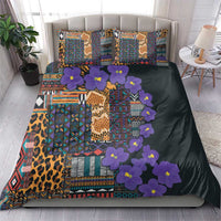 Dark bedding set with tribal patchwork, purple flowers, leopard accents, and 2 pillows