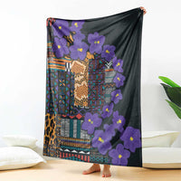 Dark tribal blanket featuring purple flowers and multicolor geometric design, draped view