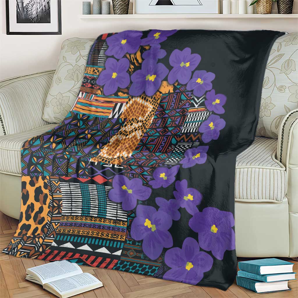 Purple flower print blanket with geometric tribal border and patterned center