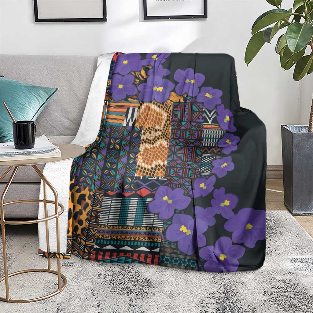Purple and dark tribal patterned blanket with glowing gold focal design and flowers