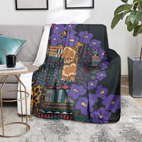 Purple and dark tribal patterned blanket with glowing gold focal design and flowers