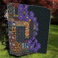 Black quilt with colorful geometric panels, leopard print heart, and purple flower clusters