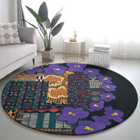 Round carpet with purple flower clusters over multicolor tribal grid pattern