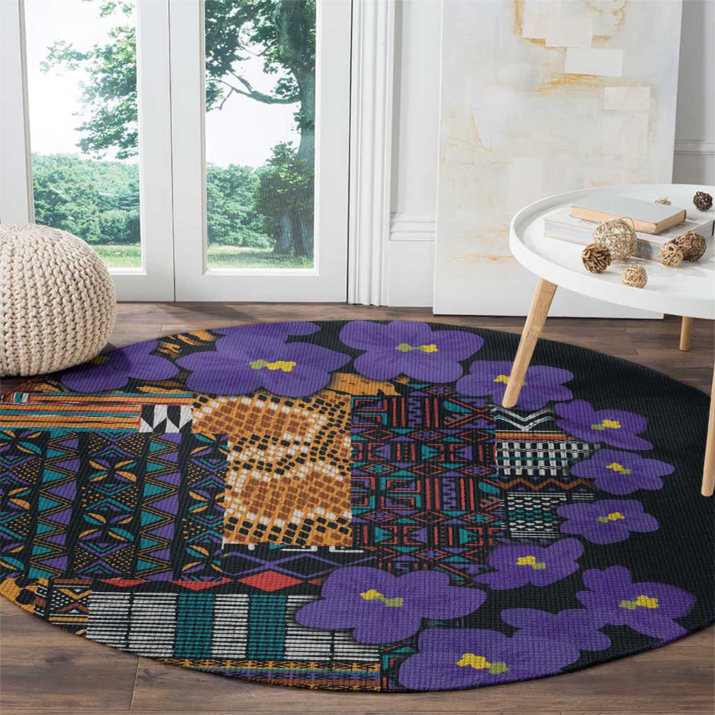 Round carpet with purple flowers and geometric tribal patchwork on dark base