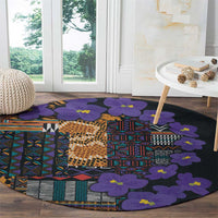 Round carpet with purple flowers and geometric tribal patchwork on dark base