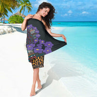 Black sarong with purple flowers and multicolor native-style border, halter wrap