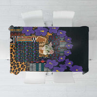 Black tablecloth with violet flowers and multicolor tribal band pattern.