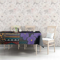 Tablecloth on a buffet: black with violet flowers and bold multicolor tribal blocks.