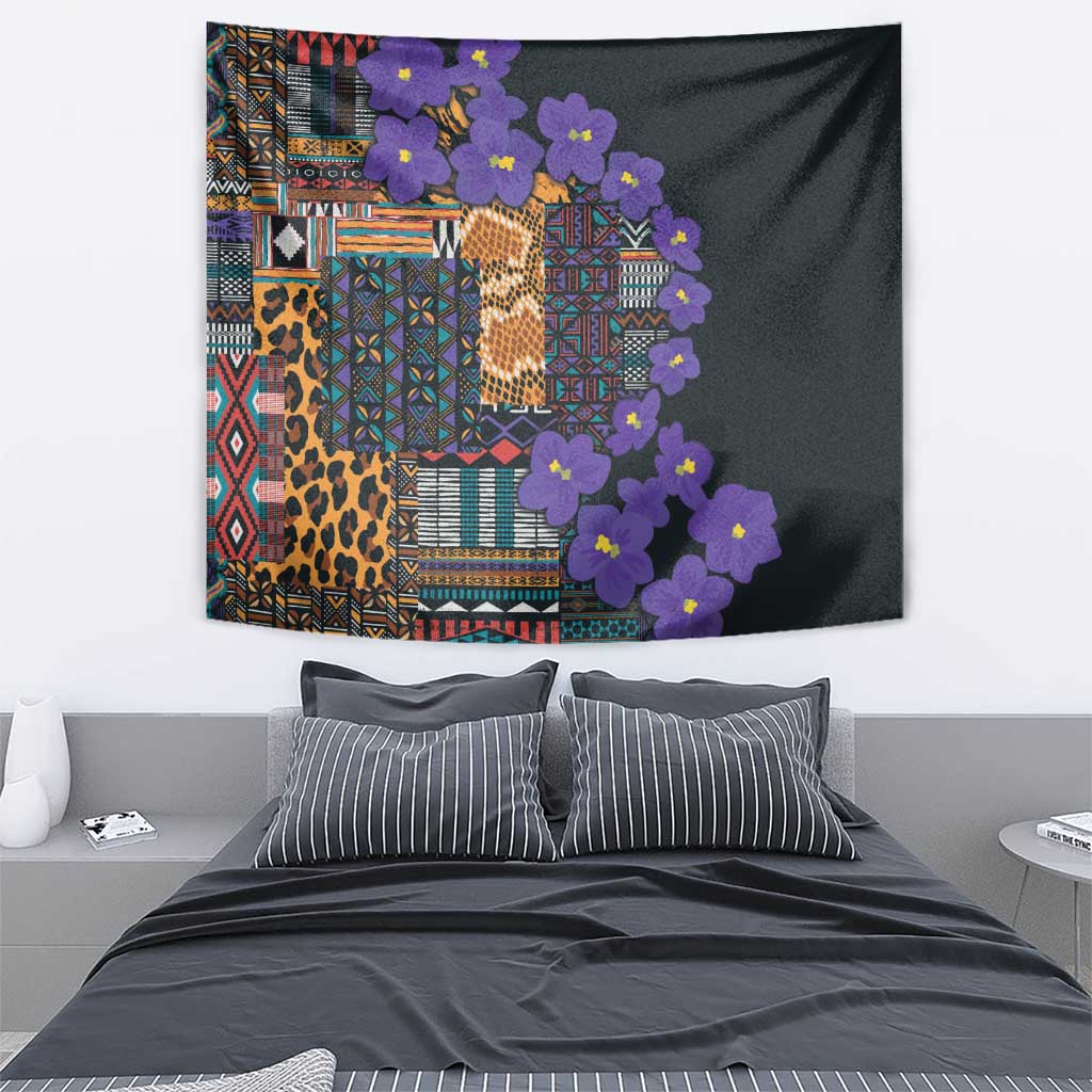 Bedroom tapestry with multicolor tribal collage, leopard print, and purple flowers on dark fabric