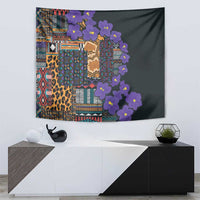 Wall tapestry with dark field, multicolor tribal blocks, leopard print, and purple flower garland