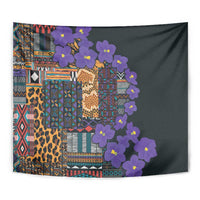Tapestry close-up: multicolor tribal geometric blocks, leopard pattern, and purple flowers