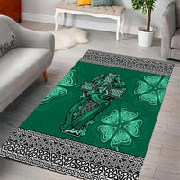 Green area rug with centered Celtic harp and cross, shamrock motifs, black-and-white border