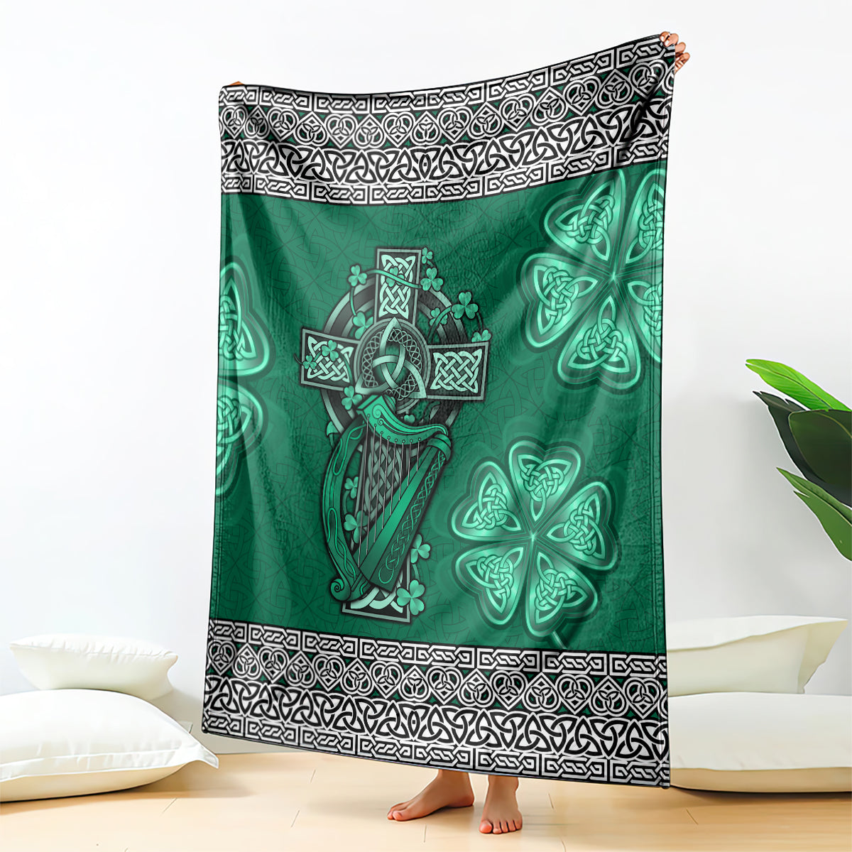 Green Celtic blanket with harp, cross, shamrock on dark green field and black-and-white border