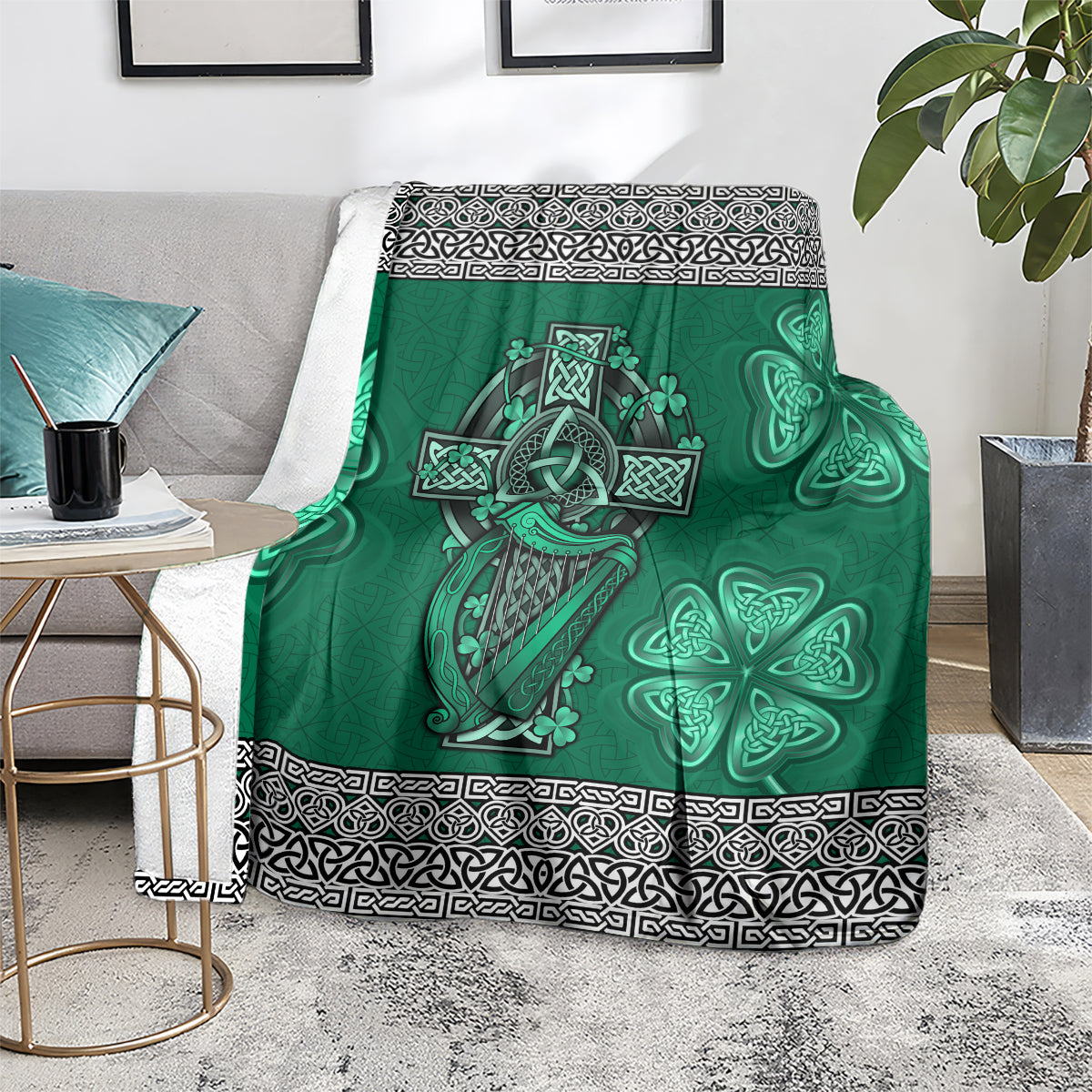 Green Celtic blanket on armchair seat, harp and shamrock artwork with patterned black trim