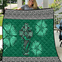 Green quilt with neon-style Celtic cross, harp and shamrock designs in turquoise on black border.
