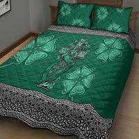 Green quilt bed set with quilt and two pillows featuring Celtic cross, harp, and shamrock motifs