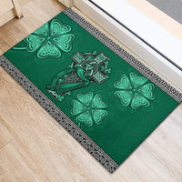 Green shamrock rubber doormat with Celtic cross and harp motif; ornate black border frame.