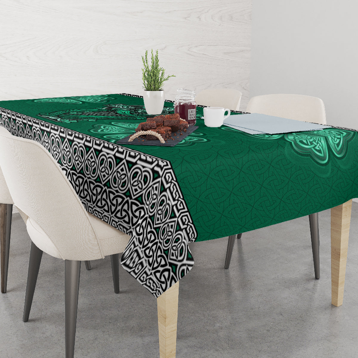Green Celtic cross, harp, and shamrock tablecloth with patterned black-and-white border
