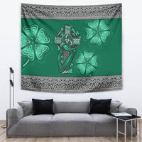 Green tapestry with central Celtic cross-and-harp and shamrock clover shapes, framed by trim