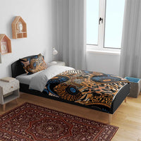 Animal motif bedding set on bed with zebra and leopard prints in blue, orange, and black