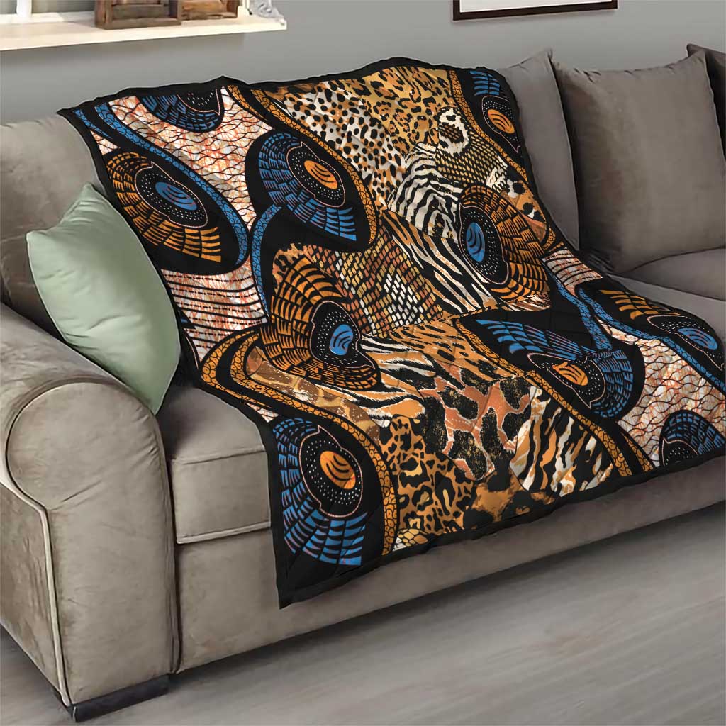 Black Ankara quilt folded on a sofa seat, showing animal-skin prints and blue circles