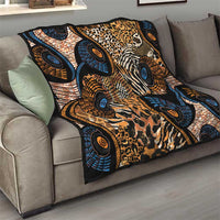 Black Ankara quilt folded on a sofa seat, showing animal-skin prints and blue circles