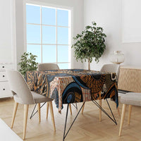 Printed tablecloth with black, orange, and blue animal-skin motifs draped on a dining table