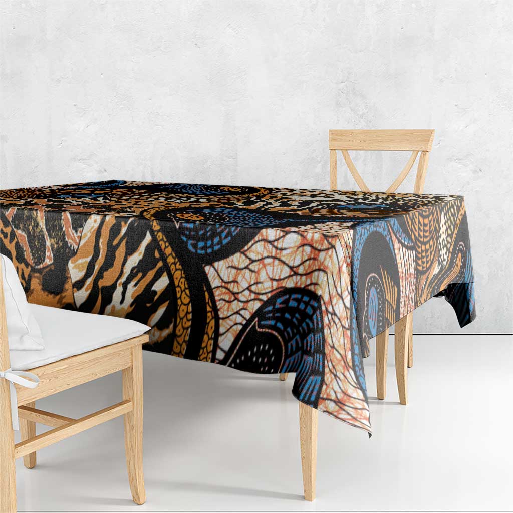 Folded black-and-tan animal-skin tablecloth with orange and blue abstract circular motifs