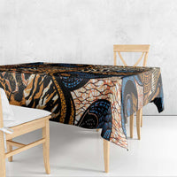 Folded black-and-tan animal-skin tablecloth with orange and blue abstract circular motifs