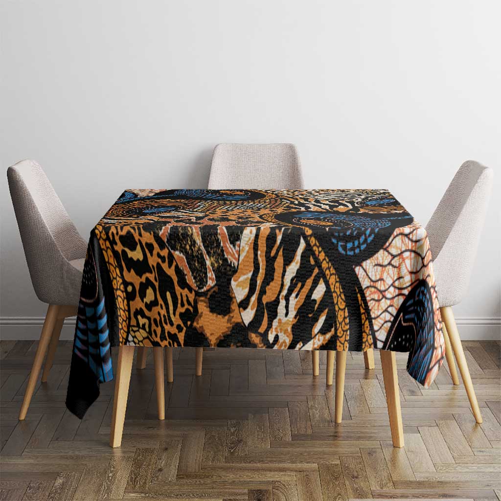 Rectangular tablecloth in black, tan, and blue with orange animal-skin motifs