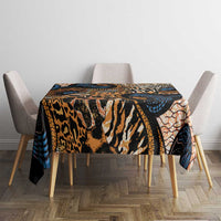 Rectangular tablecloth in black, tan, and blue with orange animal-skin motifs