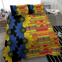 Black kitenge-style bed set with blue and yellow flower motifs and colorful grid patchwork