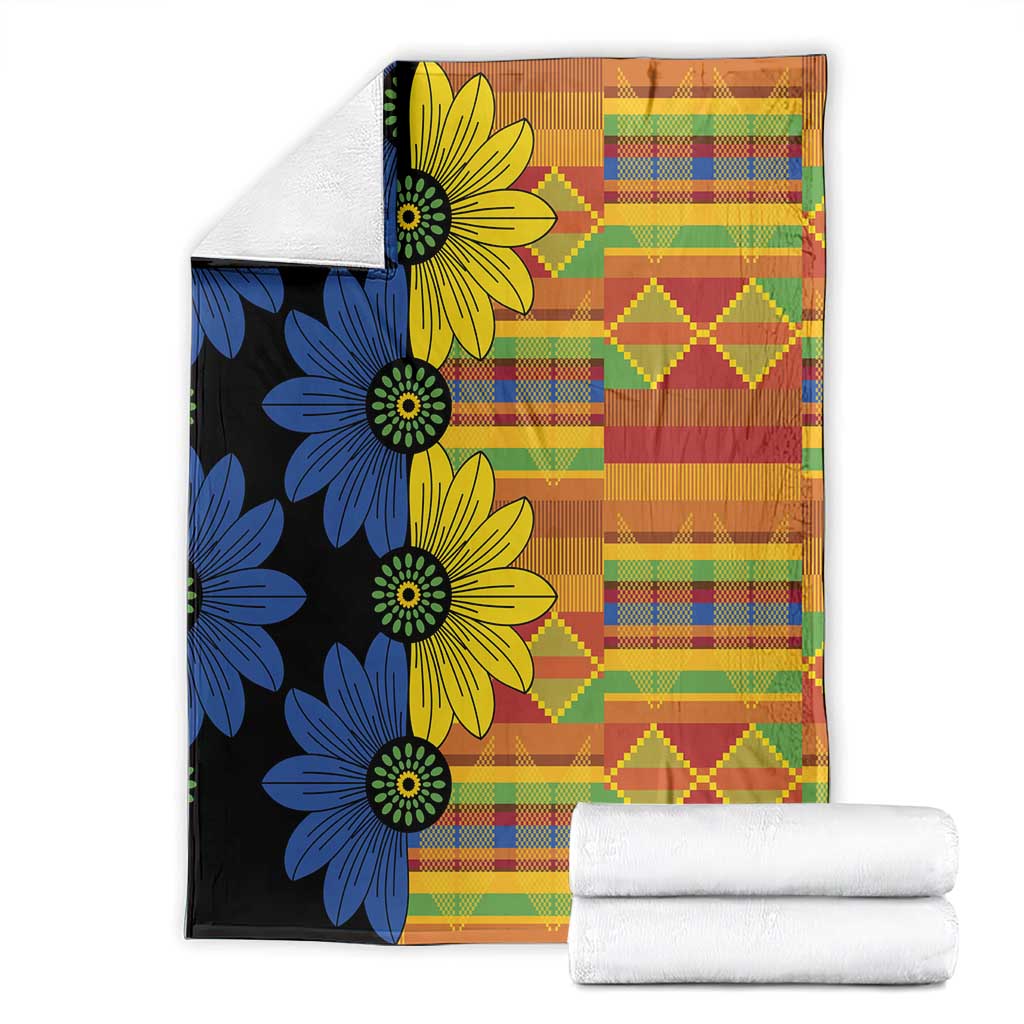 Folded kitenge-style blanket showing blue and yellow flowers on black with multicolor plaid