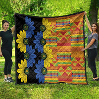 Oversized black quilt with blue and yellow floral motifs and multicolor geometric pattern