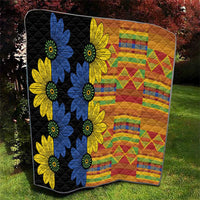 Black quilt with blue and yellow flower appliques and bright colorful patchwork blocks