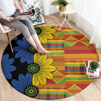 Round kitenge-style carpet, black base with yellow, blue floral print and multicolor geometry
