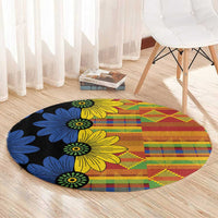 Round kitenge-style carpet, black base with yellow and blue floral pattern and multicolor checks