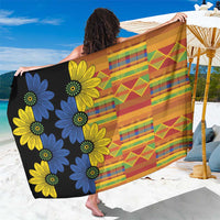 Black kitenge-style sarong with multicolor stripe and floral print, folded and held out