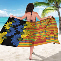 Black kitenge sarong worn as a wrap skirt, multicolor grid stripes and flower motifs