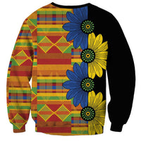 Unisex sweatshirt with black panels, kitenge patchwork front, and bold blue floral print